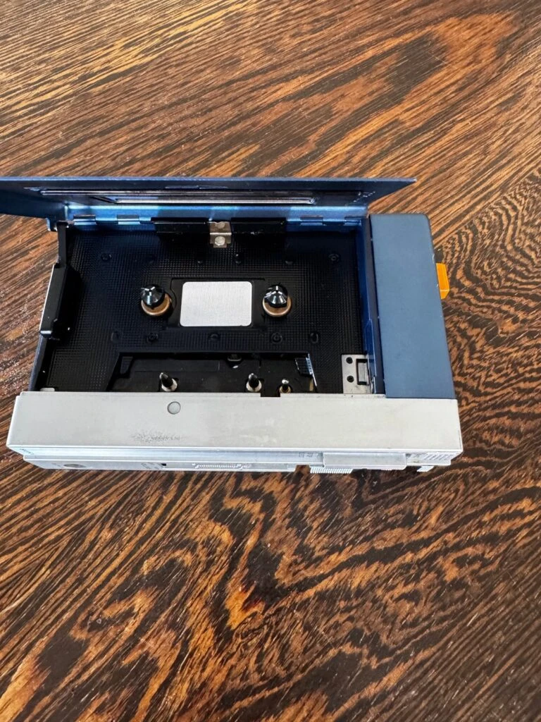 TPS-L2 with the cassette door open, showing the bay where the head, capstan and pinch roller sit
