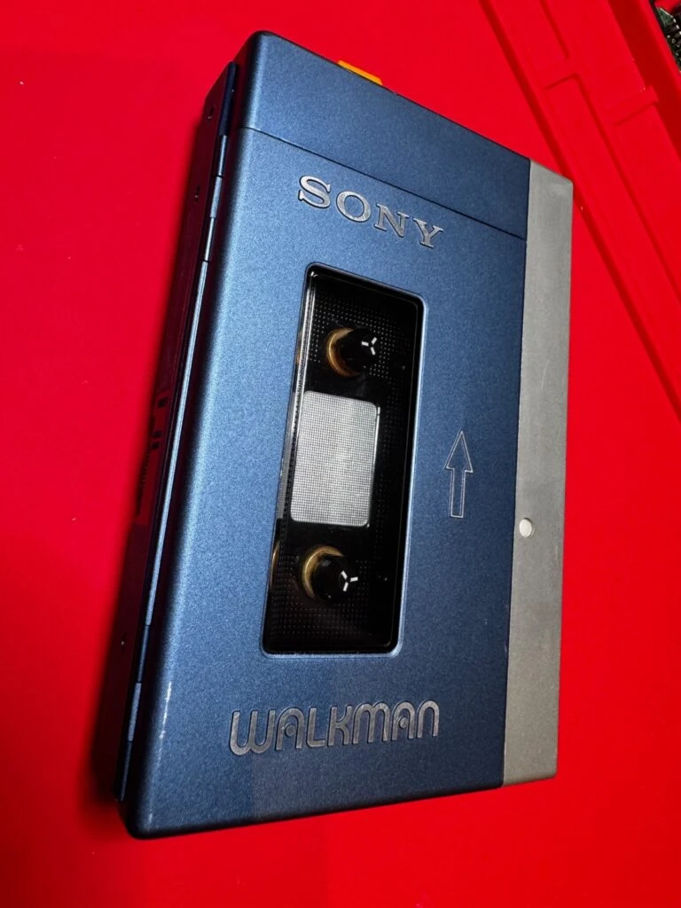 The restored Sony TPS-L2 back together, on a red background